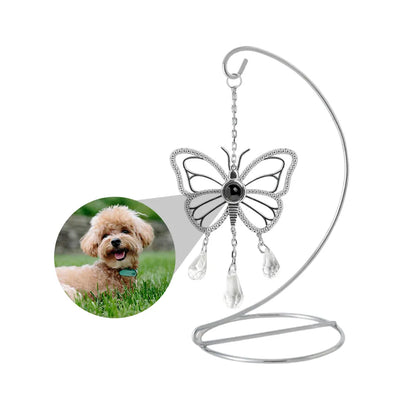 Custom photo sun catcher in a butterfly shape that can be customized with photo, is hanging on a tabletop stand